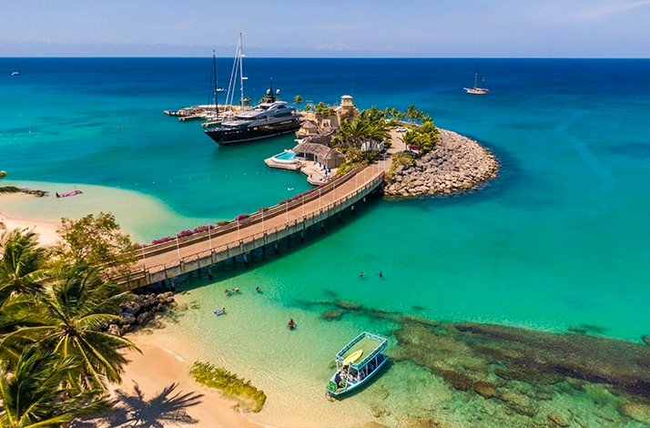 A small island connected to the beach with a thin road captured from bird eye view