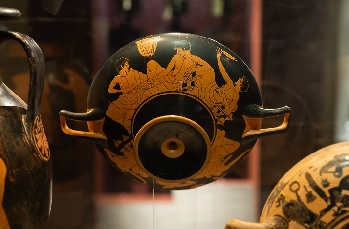 An ancient amphora with painting displaying men figures at Museum of Cycladic Art in Athens.