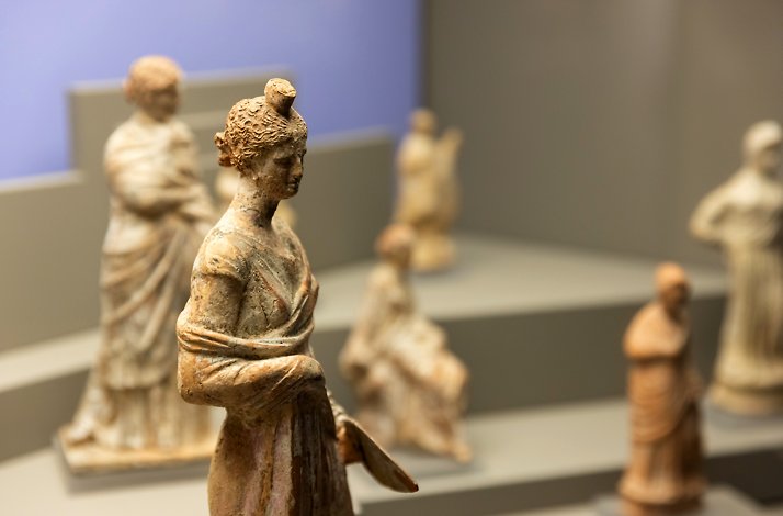 Cycladic marble figurines displayed in museum cases at Museum of Cycladic Art in Athens.