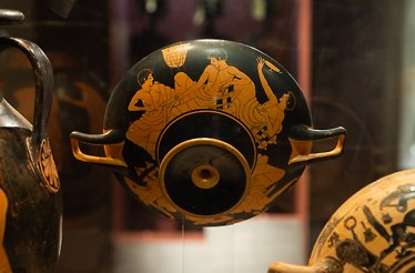 An ancient amphora with painting displaying men figures at Museum of Cycladic Art in Athens.