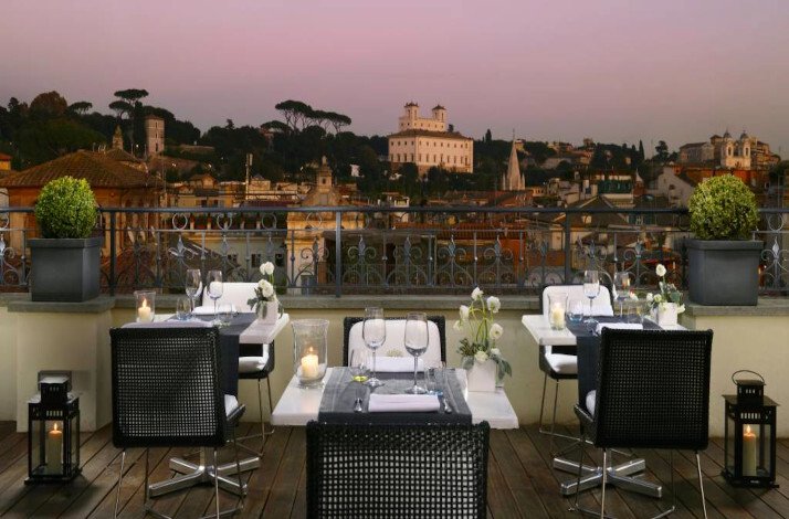 Outdoor dining area with a view of Rome at  All'Oro