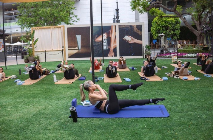 Amy Jordan, Wundabar founder, leading a pilates class in a park