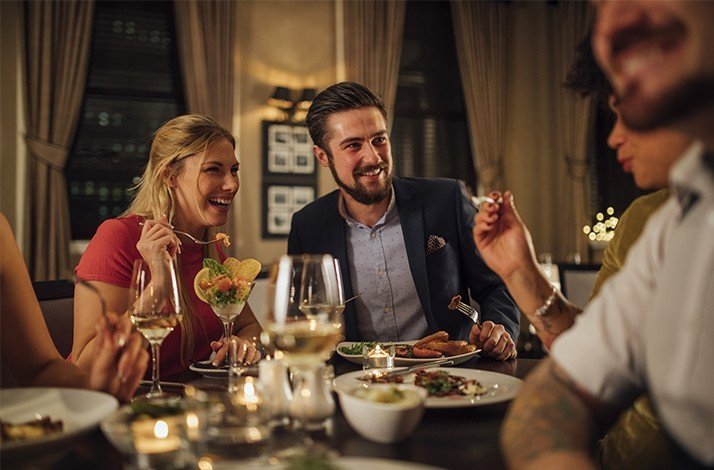 A pair of people having dinner together at Half Moon Resort, enjoying a nice dinner