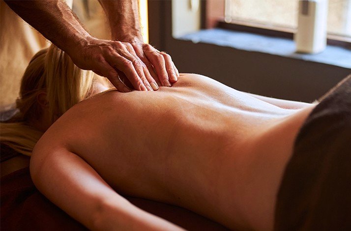 The lady is having a deeply relaxing back massage at the Half Moon's award-winning Fern Tree Spa.