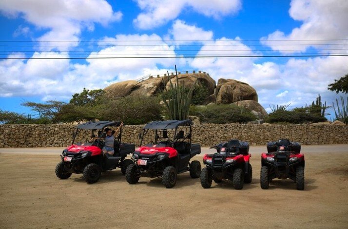 Four ATVs lined up and ready for a tour around iconic landmarks in Aruba.