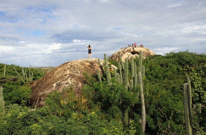 Tourists exploring the Casibari rock formations in Aruba.