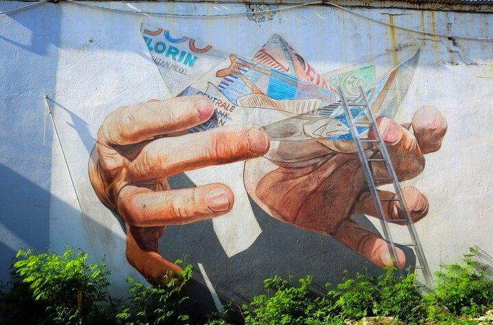 The vibrant street art showcasing an artistic representation of the origami and hands in San Nicolas.