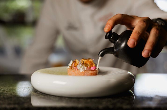 Chef Stjepan Vukadin pouring syrup on special dish for the dinner at  il Ponte.