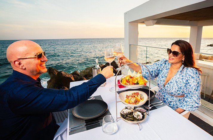 A couple having dinner at luxurious Saint Tropez Ocean Club in Willemstad settled into the beachfront seats.