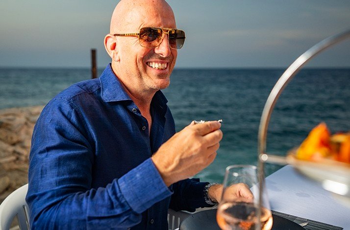 A man tasting happily tuna tacos at luxurious Saint Tropez Ocean Club in Willemstad.