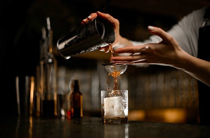 A bartender preparing a cocktail.