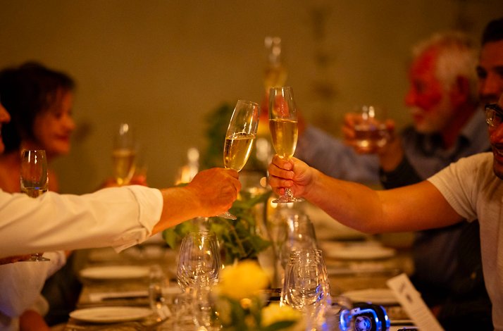 Two men clinking glasses of champaign during an exclusive SecretEATS mystery dinner at a surprise venue in Johannesburg.