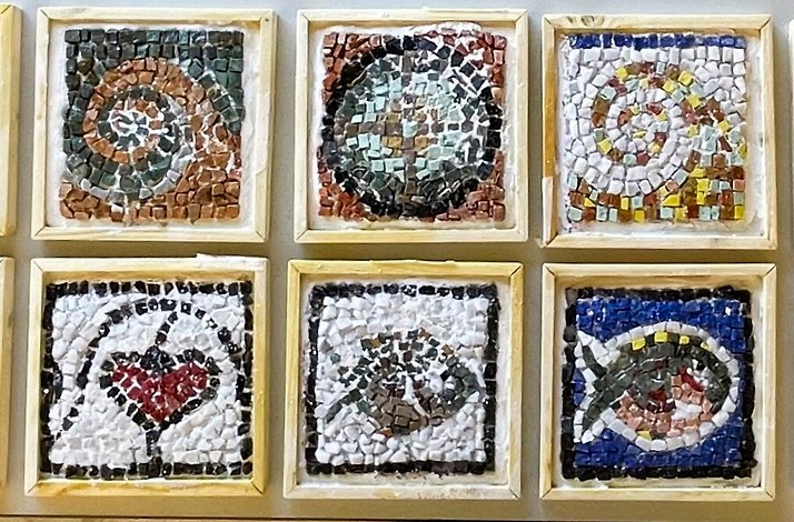 Mosaics in frames on the wall.