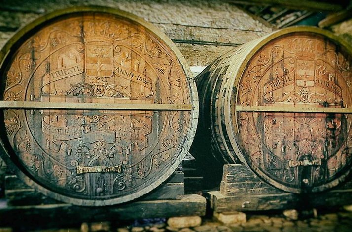 A pair of wooden barrels featuring traditional carvings on the surface at the vineyard Achaia Clauss.