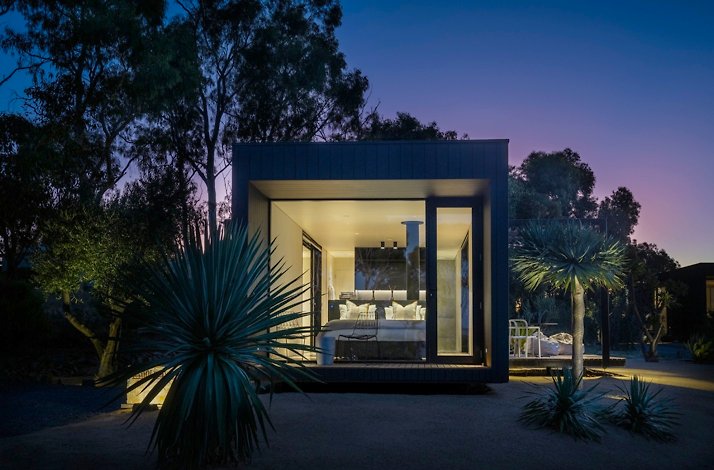 A room with panorama windows captured during the night