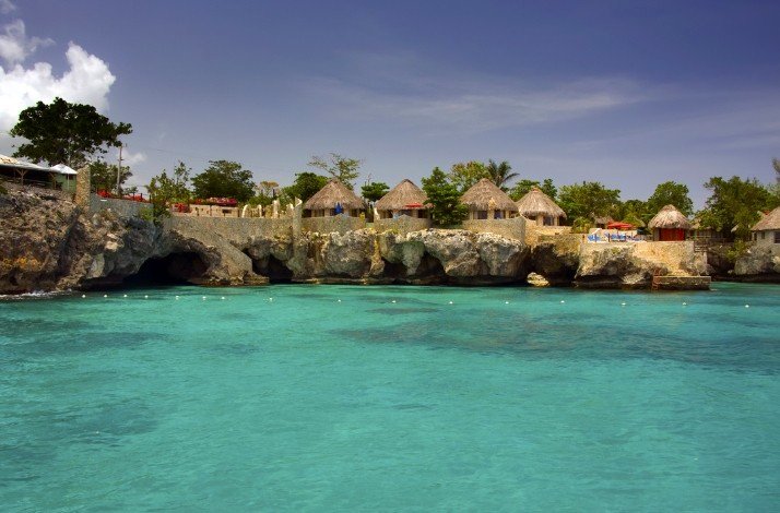 Hotel huts on the coast of the Caribbean Sea, view from the sea.
