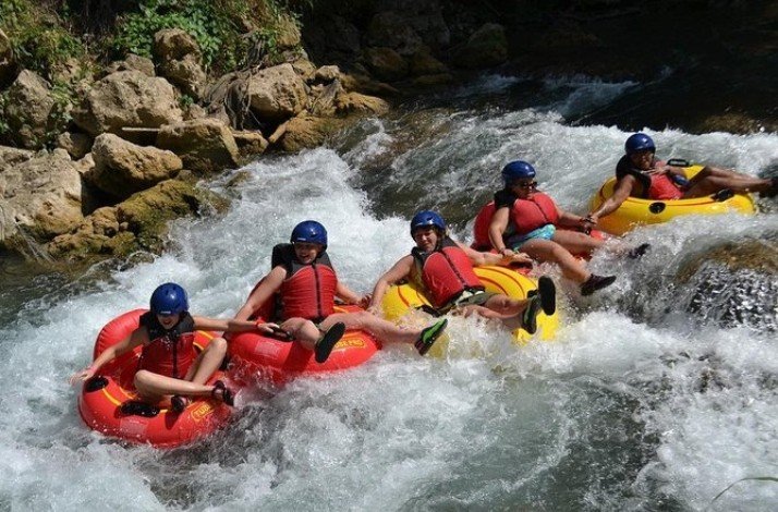 Group of tourists on a river-tubing tour of Jamaica's famous Rio Bueno