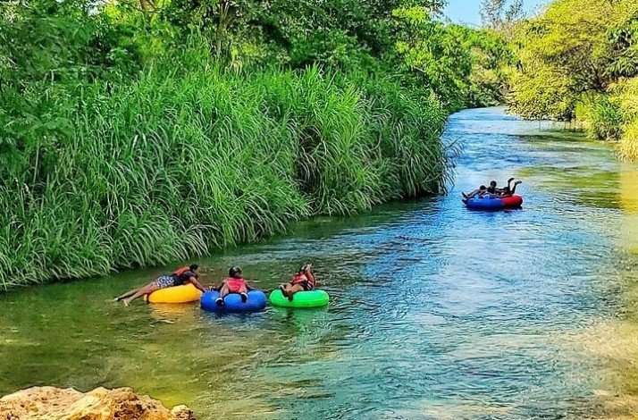 Group of tourists on a river-tubing tour of Jamaica's famous Rio Bueno