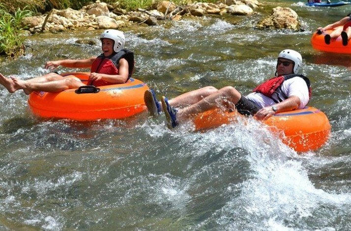 Group of tourists on a river-tubing tour of Jamaica's famous Rio Bueno