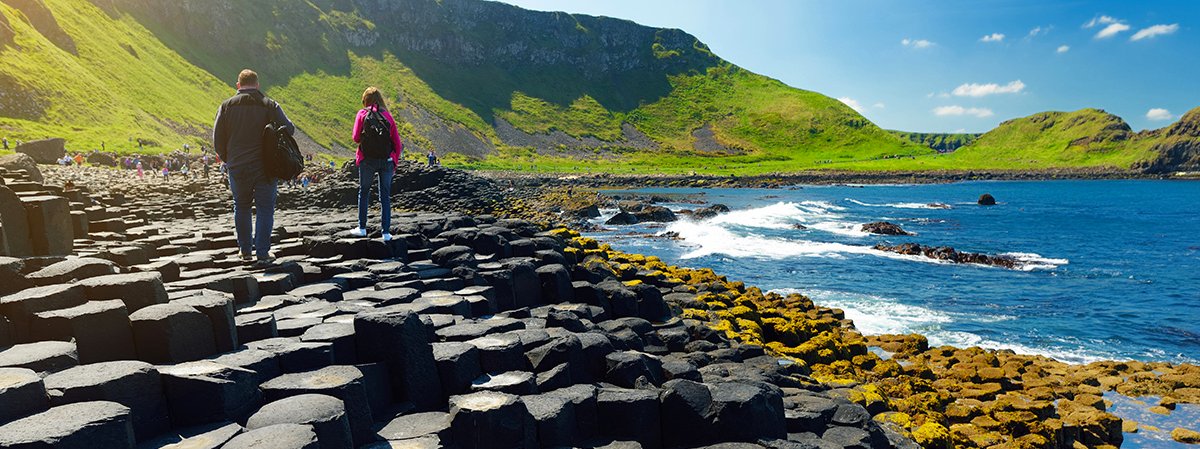 People walking on the basalt columns at Giant's Causeway, Northern Ireland.