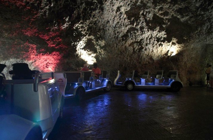 Visitors riding in a tourist mini-train through the caves of the Harrison's Cave Eco-Adventure Park.