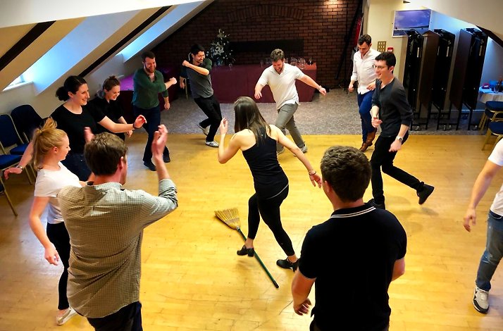 A group of  people standing in a circle during Irish dance lesson