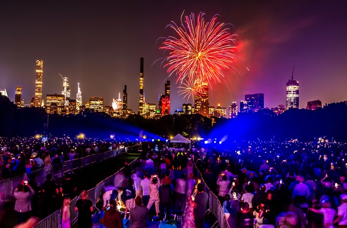 Fireworks explode above the NYC skyline during the New York Philharmonic Concerts in the Parks at Central Park.
