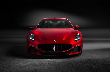 A front view of the luxurious twin-turbo V6 engine, Trofeo version Maserati GranTurismo on the black background.