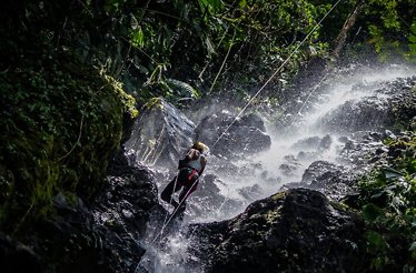 A person using a zipline over a river