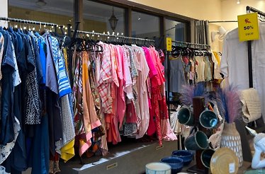 Racks and shelves with clothes and accessories in one of the clothing stores in Panjim, India.
