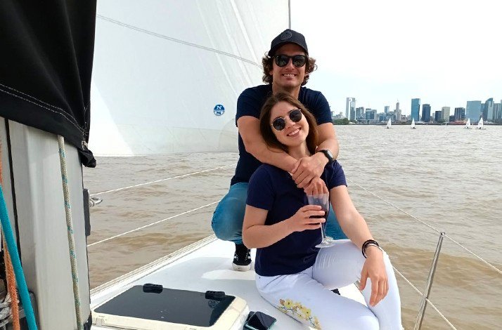 A couple enjoying a serene moment together on a sailboat at Argentina.