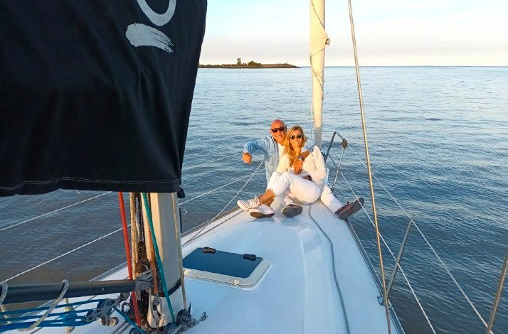 A couple enjoying a serene moment together on a sailboat at Argentina.