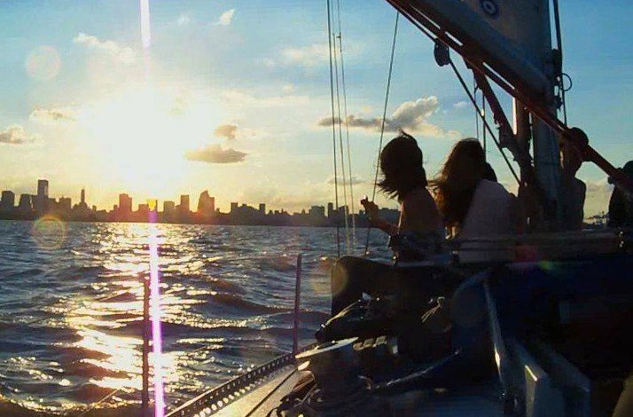 A group of individuals enjoying a sailboat ride as the sun sets at Buenos Aires.