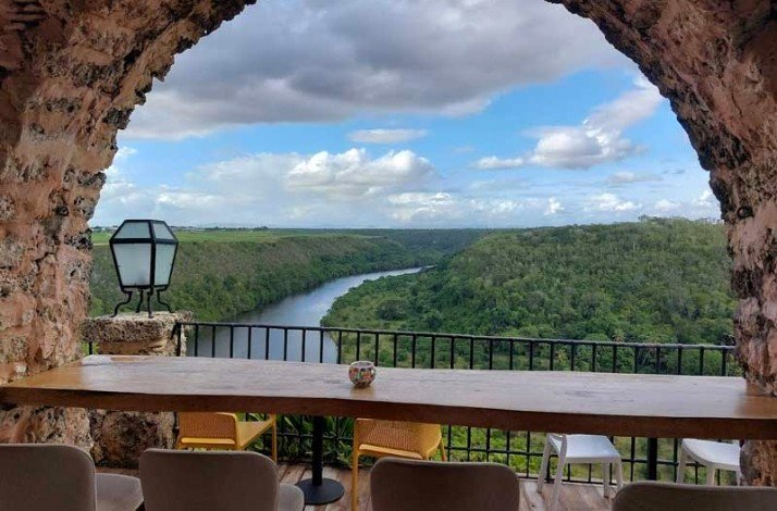 View of river in wildlife from a restaurant dining area at a veranda.