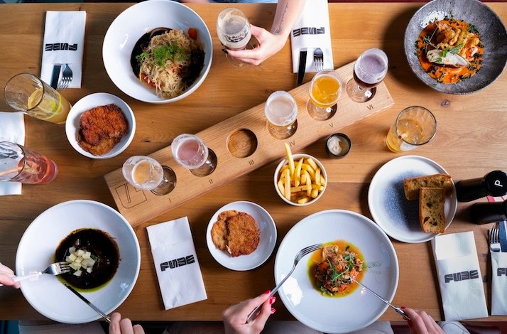 A set table with served dishes at FUZE restaurant.