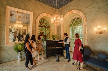 A group of people on a tour of Menezes Braganca House