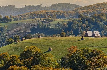 A scenic hillside with a prominent house situated on its incline