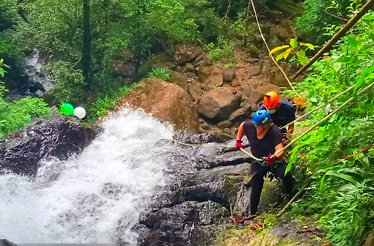 Participants climbing Sleeping Indian Mountain with special equipment and helmets.