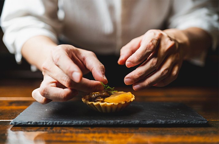 Chef Mervyn Pee garnishing an onion tart