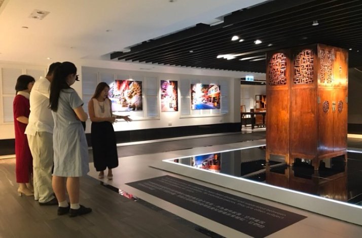 Group of people listening to the guide during after-hours museum tour.