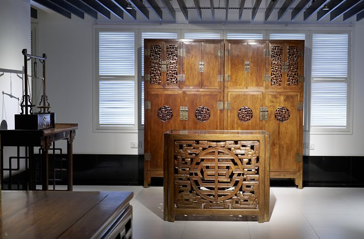 Exhibited wooden wardrobe from Chinese treasures on an after-hours museum tour.