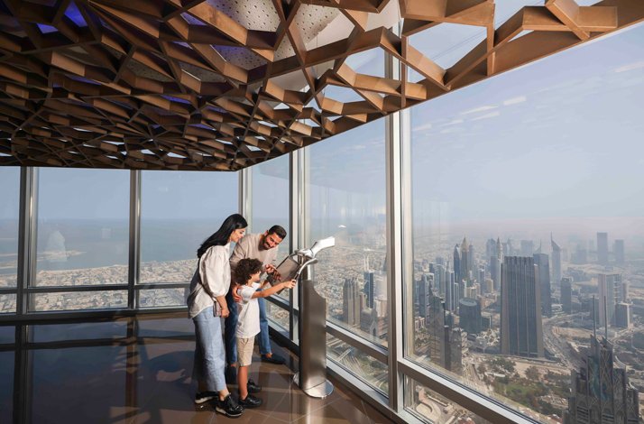 Parents and son enjoy the views from At the Top, Burj Khalifa.
