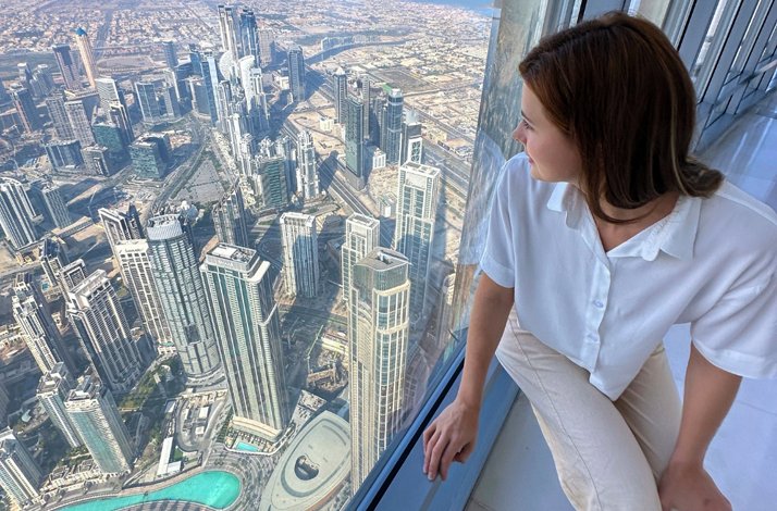 Girl looking at beautiful buildings At the Top, Burj Khalifa.