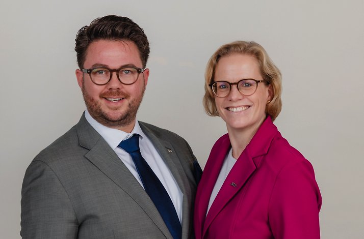 A man and a woman in suits for the fine dining experience at Carelshaven.