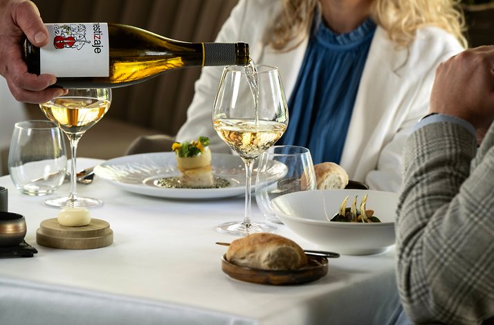 Wine poured during gourmet fine-dining experience.