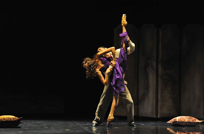 Two ballet dancers performing on stage.