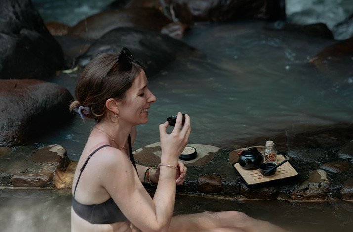 female tourist on a natural spring found in Jatiluwih's farm tour