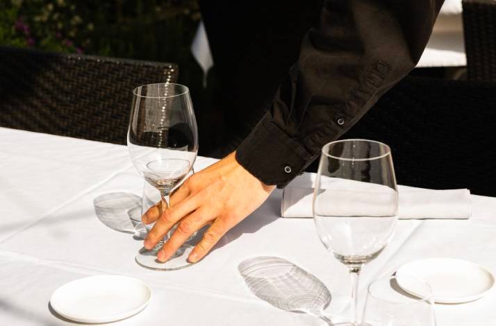 A person holding a fine glass cup