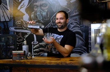 Bartender pouring a drink at the House of Spirits store, Brix.