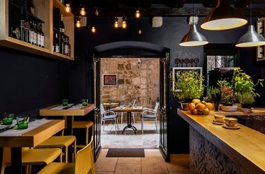 Promotional photo of Marco Polo restaurant dining area. Wines are on display on the wall.